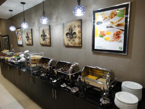 a buffet line in a restaurant with dishes at Holiday Inn Covington by IHG in Covington