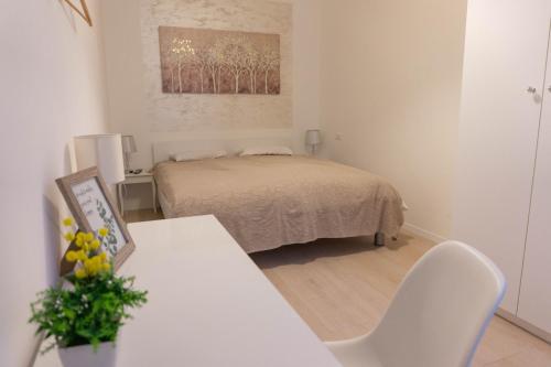 ein Schlafzimmer mit einem Bett und einem Tisch mit einem Stuhl in der Unterkunft Apartment Maksimir Yard Zagreb in Zagreb
