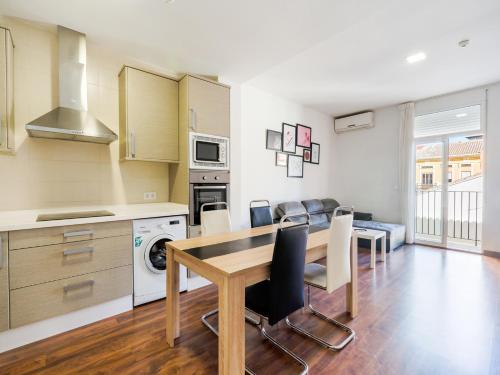 a kitchen and dining room with a table and chairs at OYO Style Apartments Puerto in Valencia