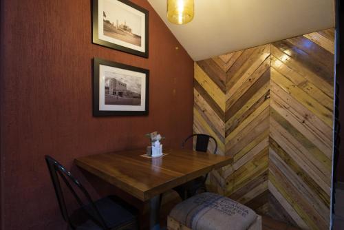 a dining room with a wooden table and chairs at Bukoto Heights Apartments in Kampala