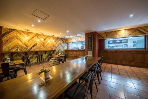 a restaurant with wooden walls and tables and chairs at Bukoto Heights Apartments in Kampala