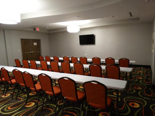 a conference room with a long table and chairs at Holiday Inn Covington by IHG in Covington