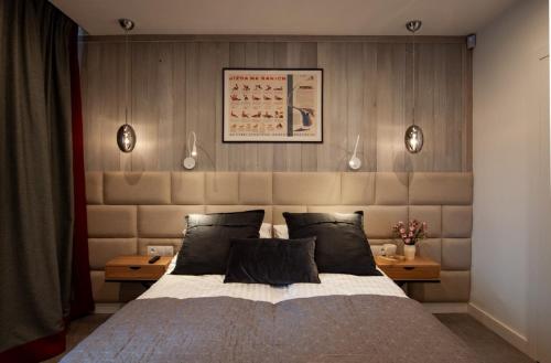 a bedroom with a large bed and two tables at Apart-Center Przy Krupówkach in Zakopane