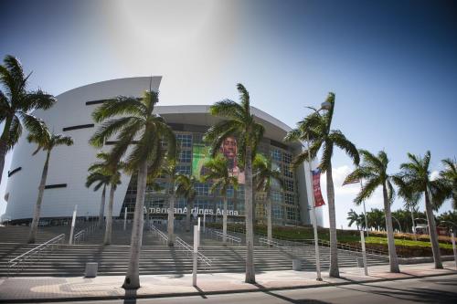 a building with palm trees in front of it at EVEN Hotel Miami - Airport by IHG in Miami
