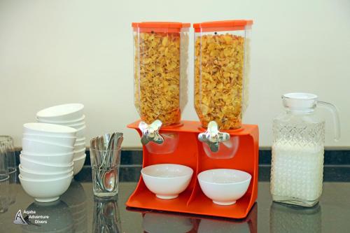a container filled with food and bowls on a table at Aqaba Adventure Divers Resort & Dive Center in Aqaba