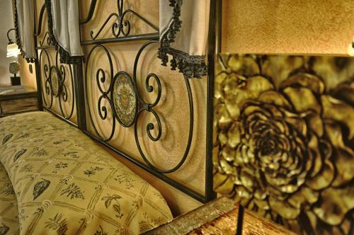 a bedroom with a bed with a wooden head board at Hotel Victoria in Taormina