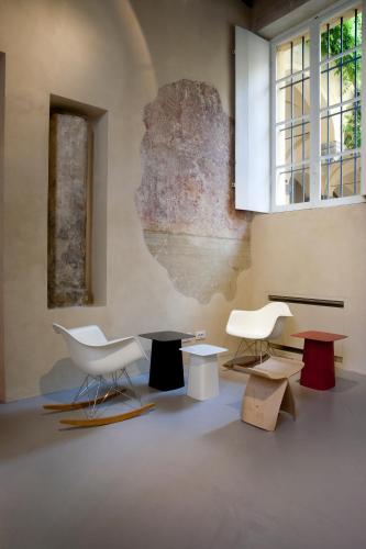 a room with chairs and tables and a wall at Palazzo Dalla Rosa Prati in Parma