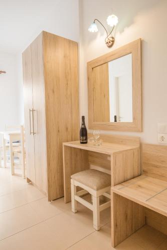 a dressing room with a desk and a mirror at Mastorakis Hotel and Studios in Hersonissos
