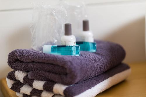 a pile of towels with two toothbrushes on top at Gasthof Bauerngirgl in Bayerisch Gmain