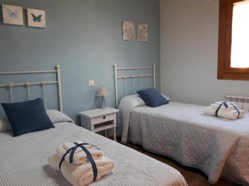 a bedroom with two beds with towels on them at La Zamarriega in Segovia