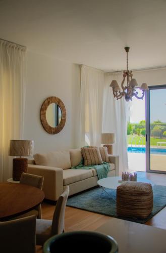 a living room with a couch and a table at Atlantis Gardens in Mazotos