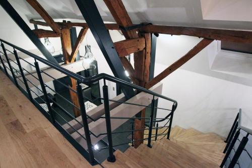 a stairwell with a bottle of wine on it at Aux 5 Sens in Tillé