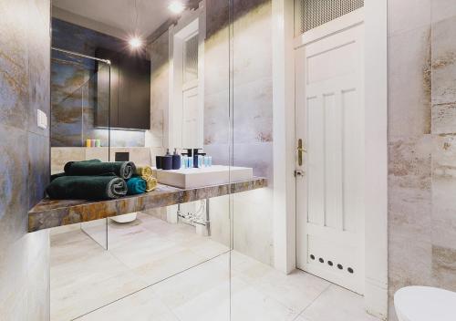 a bathroom with a sink and a mirror at Centre Apartments-Old Town in Krakow