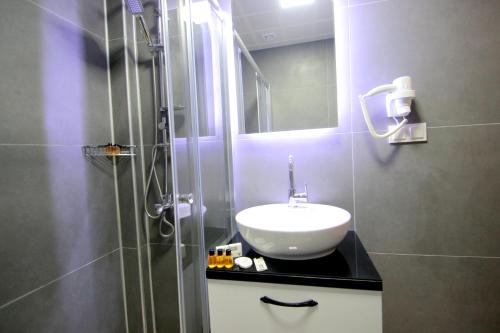 a bathroom with a sink and a shower at Hira Hotel in Istanbul