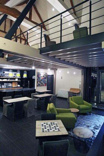 a living room with a chess game on a table at Aux 5 Sens in Tillé