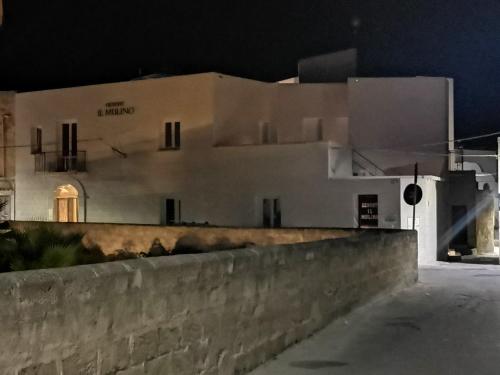 a building with a clock on the side of it at Resort Il Mulino in Favignana