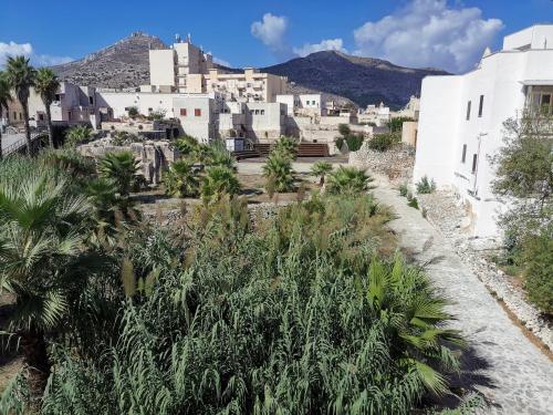 a view of a town with palm trees and buildings at Resort Il Mulino in Favignana