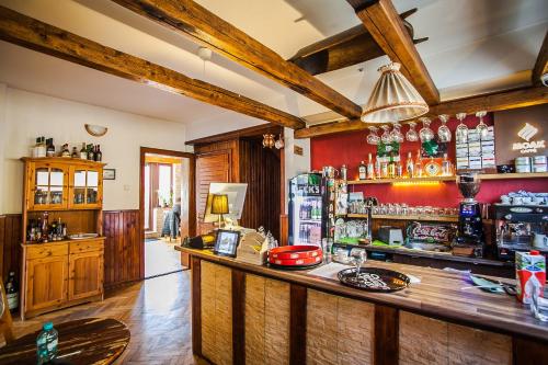 a bar with a wooden counter in a room at Casa Thomas Bran in Bran