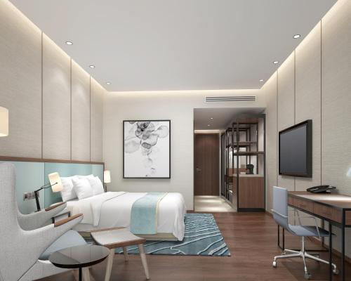 a hotel room with a bed and a desk at Hyatt Regency Thrissur in Trichūr