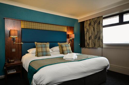 a bedroom with a large bed with a blue wall at Banff Springs Hotel in Banff