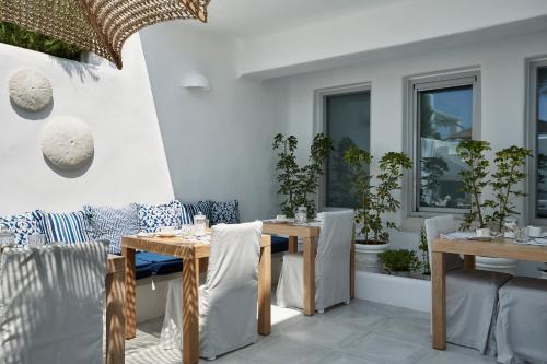 a dining room with tables and chairs and windows at White Dunes Luxury Boutique Hotel in Santa Maria
