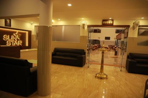 a lobby with couches and a sun star sign at Sunstar Residency & Food Plaza Pala in Lālam