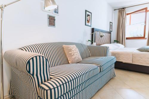 a living room with a couch and a bed at Apartments Pri nas in Kobarid