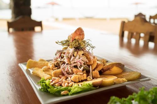 a plate of food with a sandwich on a table at Hotel Puerto Inka in Chala