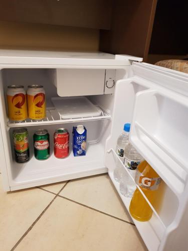 an open refrigerator filled with drinks and soda at Pousada Mirante da Serra Fonte Sônia-Valinhos in Valinhos