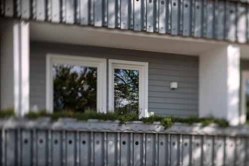 a house with a fence and a window at Berg und Tal Hotel & Apartments in Braunlage