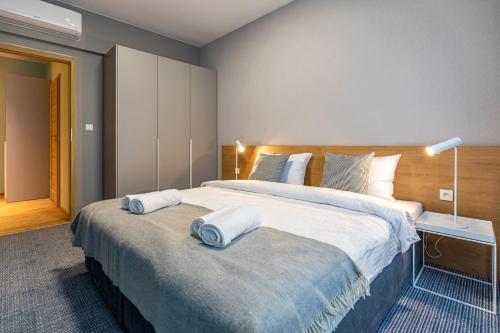 a bedroom with a large bed with two towels on it at Cotton House in Łódź
