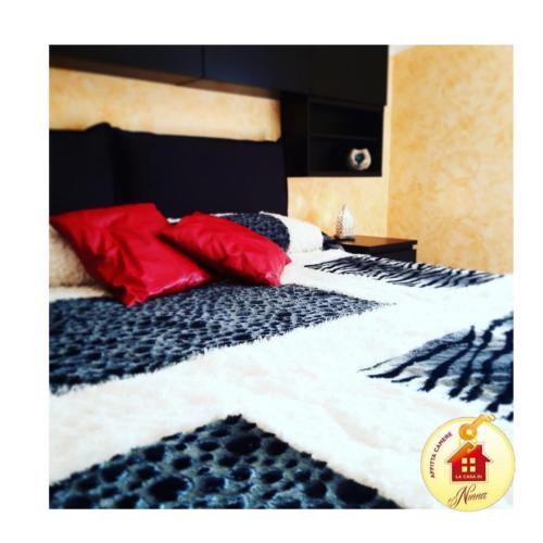 a bedroom with a bed with red pillows on it at La Casa di Ninna Affittacamere in Ariano Irpino