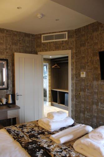 a bedroom with a bed with two towels on it at The Lord Street Hotel; BW Signature Collection in Southport