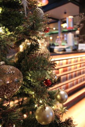 a christmas tree with ornaments in a store at The Lord Street Hotel; BW Signature Collection in Southport