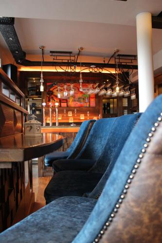 a restaurant with blue velvet chairs and a table at The Lord Street Hotel; BW Signature Collection in Southport