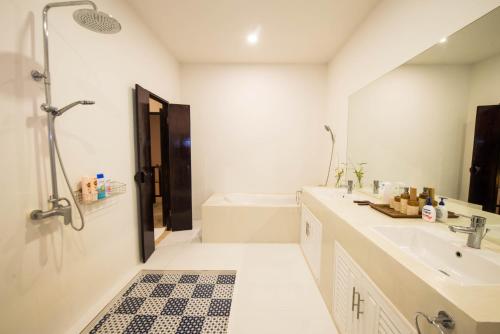 a bathroom with a shower and a sink and a tub at Teak Hill Pool Villa-Rosewood in Ko Chang
