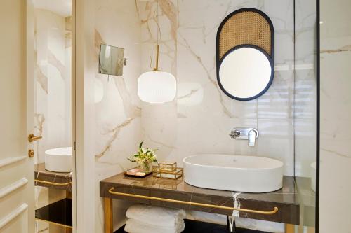 a bathroom with a sink and a mirror at The Excelsior Small Luxury Hotels of the World in Thessaloniki