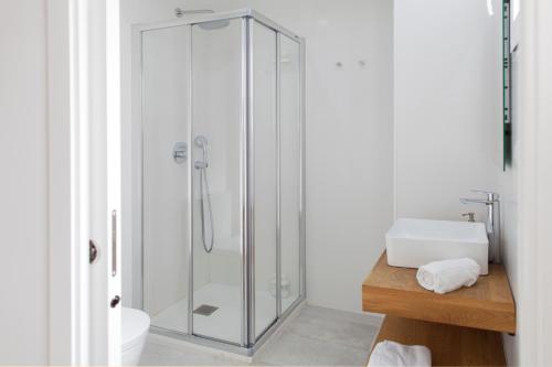 a glass shower in a bathroom with a sink at FLORIT FLATS - Apartment Torres de Quart II in Valencia