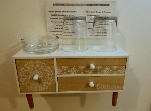a cabinet with two glass jars on top of it at Apartments Rooms FONTANE TRNJE - FREE PARKING in Zagreb