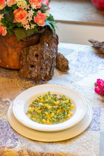 a white plate with corn salsa on a table at Rifugio Monte Baldo in Avio
