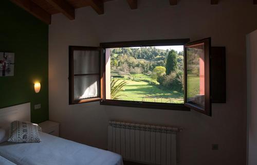 a bedroom with a bed and a large window at Apartamento Vega Rodiles El Valle in Villaviciosa