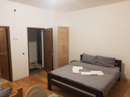 a small bedroom with a bed and a mirror at Pansion Radgost, Rtanj in Rtanj