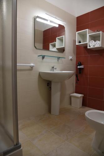 a bathroom with a sink and a mirror at B&B La Graticola Ristorante Pizzeria in Trepuzzi