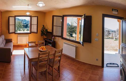 a living room with a table and a couch at Apartamentos Vega Rodiles la huerta in Villaviciosa