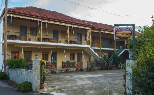 a large yellow building with a sign in front of it at Avgi in Kato Loutraki