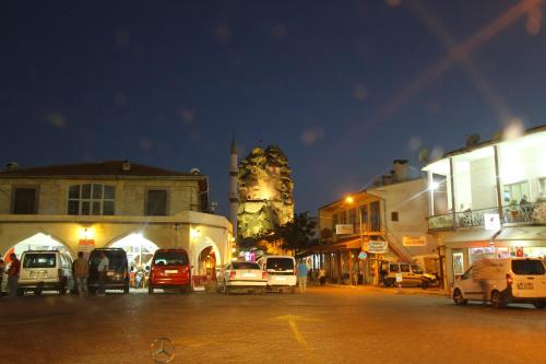 a group of cars parked in a street at night at Asmir Suites Hotel in Nevsehir