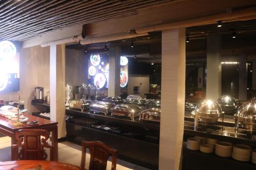 a kitchen with many pots and pans on display at Chang Palace Vientiane in Vientiane