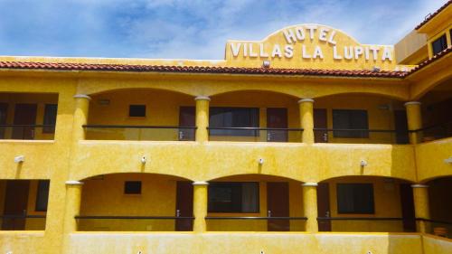 a hotel with a sign on top of it at Villas La Lupita in Acapulco