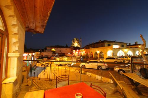 a balcony with a view of a city at night at Asmir Suites Hotel in Nevşehir