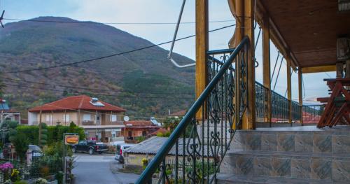 a house with a staircase with a mountain in the background at Avgi in Kato Loutraki